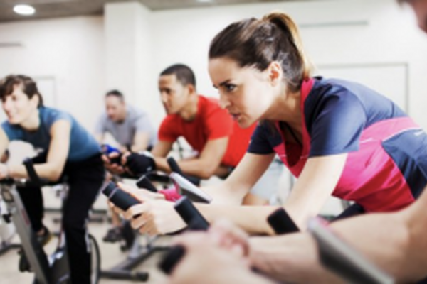 a group fitness class with participants on exercise bikes