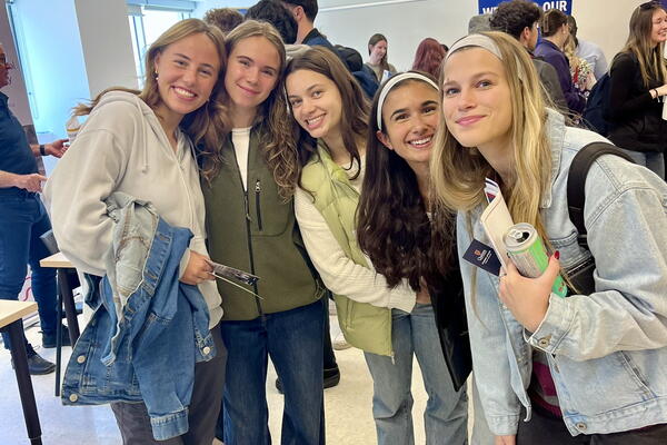 A group of smiling people at a career fair.