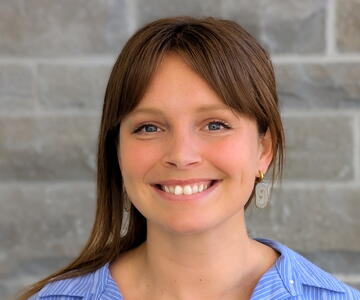 Clara smiling in blue shirt