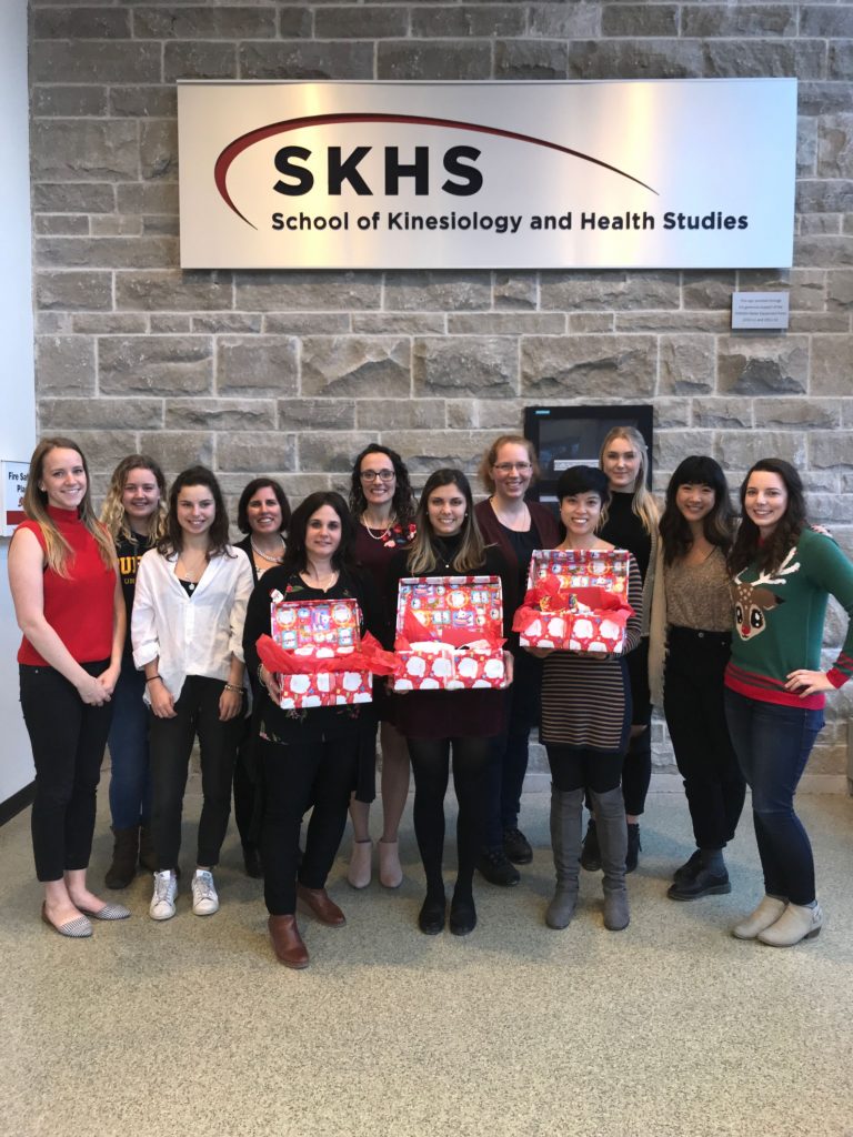 A group of SKHS students holding gift boxes