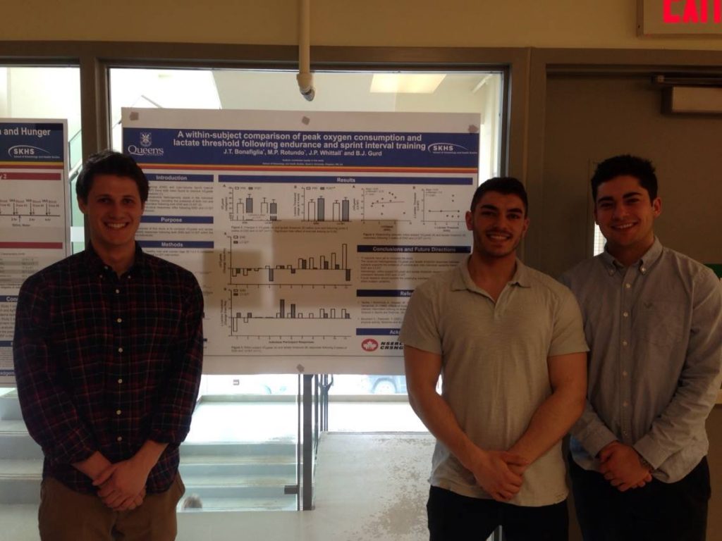 A group of students in front of a research board